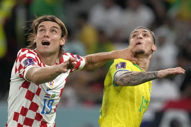 Croatia's Borna Sosa, left, fights for the ball with Brazil's Antony during the World Cup quarterfinal soccer match between Croatia and Brazil, at the Education City Stadium in Al Rayyan, Qatar, Friday, December 9, 2022. (Photo by Frank Augstein/AP Photo)