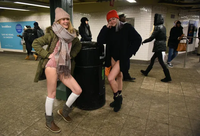 Participants in the 17th Annual “No Pants Subway Ride” travel through a New York City subway station on January 7, 2018 in New York. (Photo by Timothy A. Clary/AFP Photo)