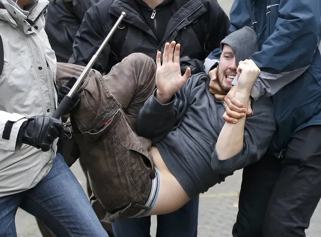 A demonstrator is carried away by plain-clothes police during a march against government reforms and cost-cutting measures in Brussels , October 7, 2015. (Photo by Francois Lenoir/Reuters)