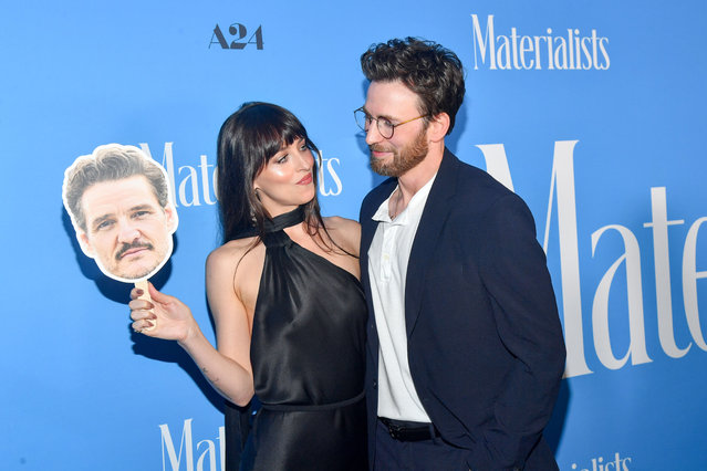 Dakota Johnson flashes a cutout of Pedro Pascal during the premiere of Materialists in New York, US on June 7, 2025. (Photo by Stephen Lovekin/Rex Features/Shutterstock)