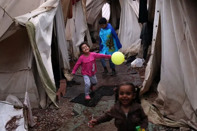 Children play among tents at Ritsona refugee camp north of Athens, which hosts about 600 refugees and migrants on Thursday, September 22, 2016. Most of the roughly 60,000 refugees and other migrants stranded in Greece are living in “appalling conditions” and face “immense and avoidable suffering”, rights group Amnesty International said in a report Thursday, slamming Europe's response to the refugee crisis. (Photo by Petros Giannakouris/AP Photo)