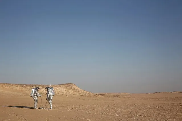 In this February 7, 2018, photo, two scientists test space suits and a geo-radar for use in a future Mars mission in the Dhofar desert of southern Oman. (Photo by Sam McNeil/AP Photo)