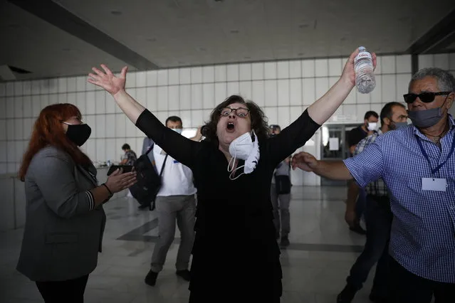 Magda Fyssa, the mother of late Greek rap singer Pavlos Fyssas, who was stabbed and killed by a supporter of the extreme right Golden Dawn party in 2013 triggering a crackdown on the party, celebrates after the announcement of a court decision in Athens, Wednesday, October 7, 2020. The court ruled that the far-right Golden Dawn party was operating as a criminal organization, delivering a landmark guilty verdict in a marathon five-year trial.The court ruled seven of the party's former lawmakers, including party leader Nikos Michaloliakos, were guilty of leading a criminal organization, while the others were guilty of participating in a criminal organization. (Photo by Petros Giannakouris/AP Photo)