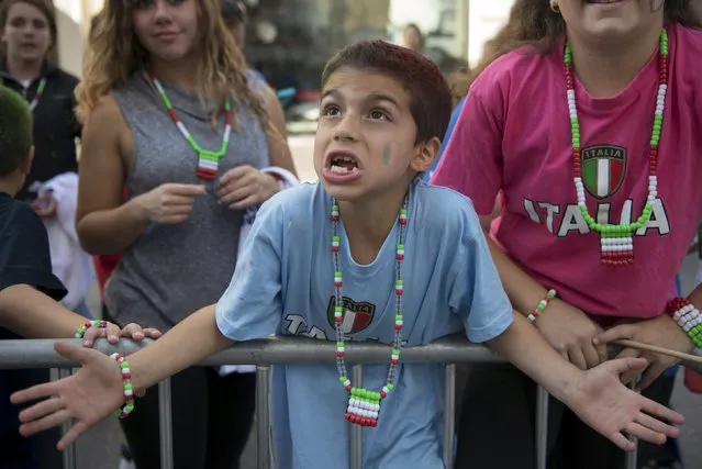 A boy gestures from the sidelines from the Columbus Day Parade on Fifth Avenue in the Manhattan borough of New York, October 12, 2015. (Photo by Stephanie Keith/Reuters)