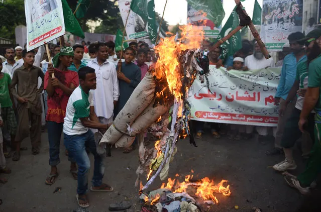 Activists of Pakistan Muslim League (Sher-e-Bangal) burn an effigy of Indian Prime Minister Narendra Modi during a protest rally in Karachi on October 2, 2016. Pakistan has flatly denied India's claim that its commandos penetrated up to three kilometres into Pakistan on anti-militant raids, saying two of its soldiers were killed but only in cross-border fire of the kind that commonly violates a 2003 ceasefire on the Line of Control (LoC). (Photo by Rizwan Tabassum/AFP Photo)