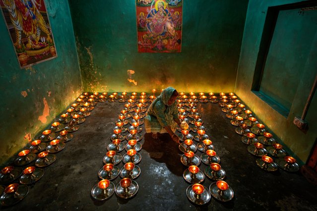 A Hindu devotee lights lamps inside the ancient Baba Sidh Goria temple on the first day of the Navratri, or nine nights festival, in Jammu, India, Tuesday, April 9, 2024. (Photo by Channi Anand/AP Photo)