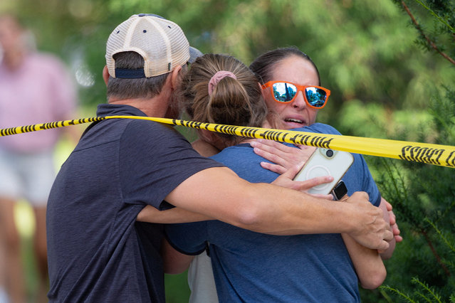 Families and loved ones reunite outside the police barricades after a shooting at Annunciation Church, which is also home to a an elementary school, in Minneapolis, Minnesota, U.S. August 27, 2025. (Photo by Ben Brewer/Reuters)