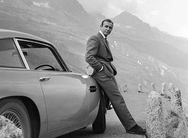 Actor Sean Connery poses as James Bond next to his Aston Martin DB5 in a scene from the United Artists release “Goldfinger” in 1964. (Photo by Michael Ochs Archives/Getty Images)