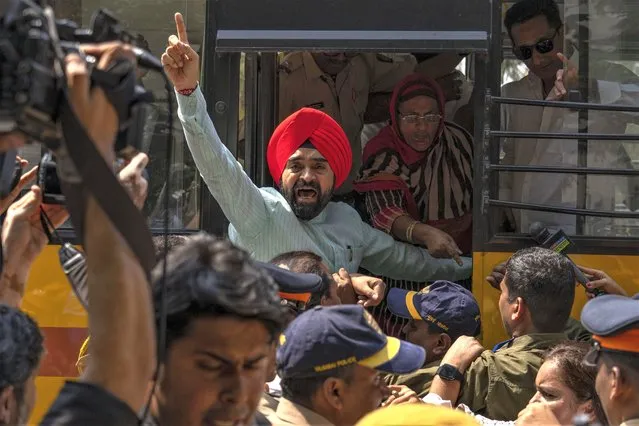 A member of opposition Congress party shouts slogans as police detains dozens who were demanding an investigation into allegations of fraud and stock manipulation by India's Adani Group during a protest outside National Stock Exchange in Mumbai, India, Wednesday, March 1, 2023. The Adani Group suffered a massive sell-off of its shares after a U.S.-based short-selling firm, Hindenburg Research, accused it of various fraudulent practices. The Adani Group has denied any wrongdoing. (Photo by Rafiq Maqbool/AP Photo)