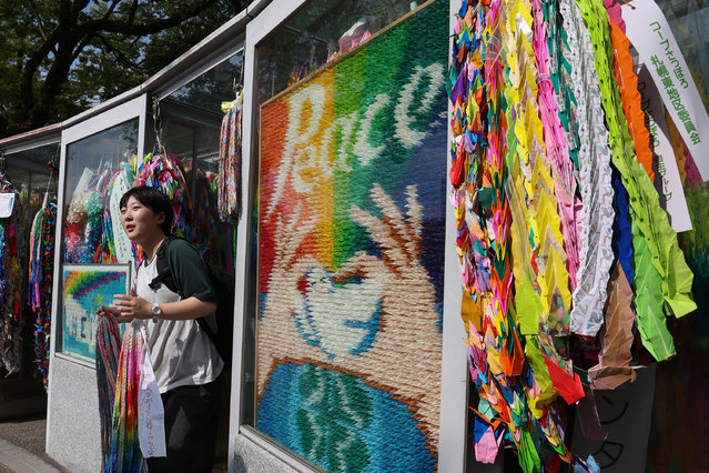 A young girl visits the Children’s Peace Monument ahead of the 80th anniversary of the atomic bomb dropped on Hiroshima at the Hiroshima Peace Memorial Park on August 05, 2025 in Hiroshima, Japan. On August 6 and 9, 1945, the United States dropped atomic bombs on the Japanese cities of Hiroshima and Nagasaki, bringing unprecedented devastation and leading to the end of World War II. The 80th anniversary marks a sombre reflection on the tragic loss and lasting impact of nuclear warfare on survivors and future generations. (Photo by Buddhika Weerasinghe/Getty Images)
