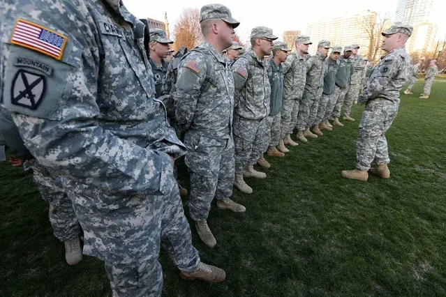 Members of the Massachusetts National Guard wait for orders on Boston Common in the evening following an explosion at the finish line of the Boston Marathon in Boston, Monday, April 15, 2013. (Photo by Michael Dwyer/AP Photo)