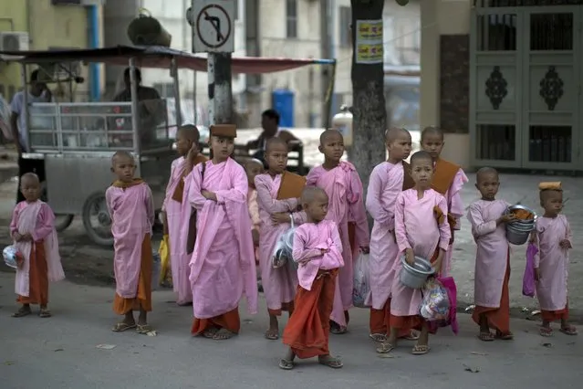 Buddhist novice nuns wait for transportation in Mandalay October 5, 2015. (Photo by Jorge Silva/Reuters)