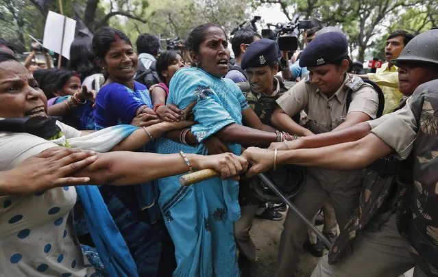 Supporters of India's main opposition Bharatiya Janata Party (BJP) scuffle with police as they march towards the residence of the chief of India's ruling Congress party Sonia Gandhi during a protest rally in New Delhi April 21, 2013. Small groups of protesters dodged police and tried to reach the homes of India's leaders in the capital New Delhi on Sunday, in a third day of protests after the alleged rape and torture of a five-year old girl. Police say the child was abducted on April 15, kept in captivity and raped by a neighbour near her north Delhi home. The accused, who had fled, was brought back to the capital on Saturday. (Photo by Adnan Abidi/Reuters)