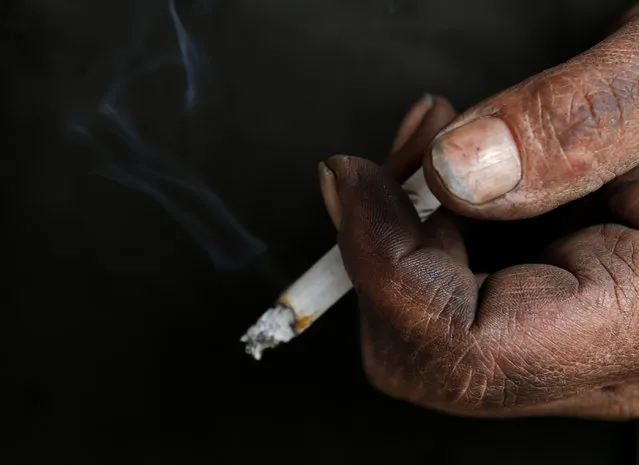 A miner holds a cigarette after his last working day at Hungary's last hard coal deep-cast mine at Markushegy December 23, 2014. (Photo by Laszlo Balogh/Reuters)