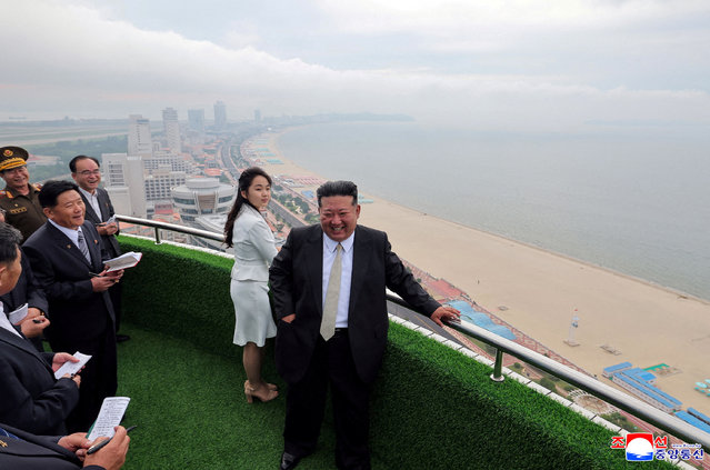 North Korean leader Kim Jong Un and his daughter Kim Ju Ae stand on a balcony facing the beach during a ceremony to celebrate the completion of the Wonsan Kalma Coastal Tourist Zone, in Wonsan, in North Korea on June 25, 2025. (Photo by KCNA via Reuters)