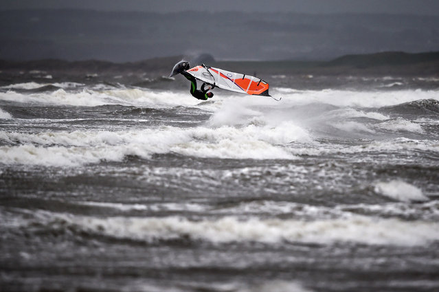 Wind surfer Douglas Paton battles with the weather at Barassie beach on November 13, 2015 in Troon, Scotland. Storm Abigail has closed schools on the Western Isles and ferries have been cancelled as gale force winds overnight left 12,000 properties without power. (Photo by Jeff J Mitchell/Getty Images)