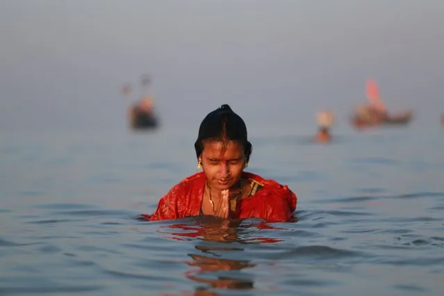 A Hindu pilgrim takes holy bath in the Bay of Bengal as they perform rituals on the occasion of the Rashmela, a religious festival in Kuakata, Bangladesh on November 30, 2020. (Photo by Rehman Asad/NurPhoto via Getty Images)