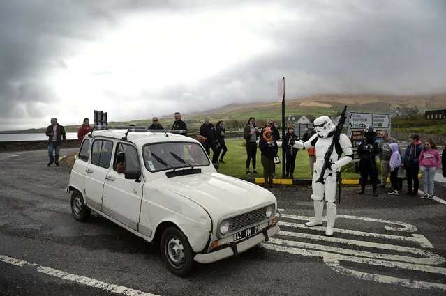 A member of the 501st Irish Legion dressed as a stormtrooper stages a mock check point on May 5, 2018 in Portmagee, Ireland. The first ever Star Wars festival is taking place against the backdrop of the famous Skellig Michael island which was used extensively in Episode VII and Episode VIII of the popular science fiction saga. The small fishing village of Portmagee which is situated close to the location has seen a boom in tourism following the latest films. (Photo by Charles McQuillan/Getty Images)
