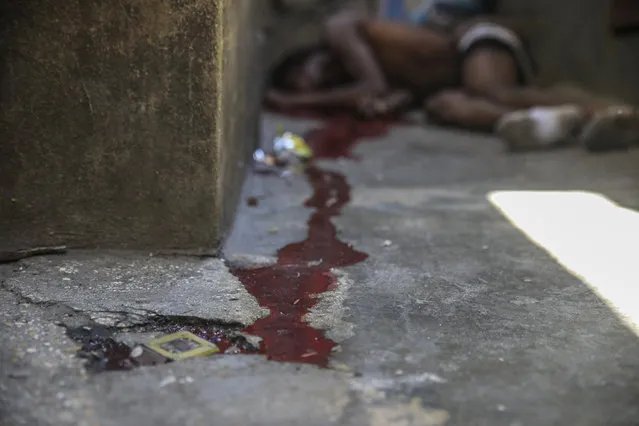 The body of Haitian comedian “Sеxy” lies on the ground after he was shot dead by unknown assailants, in Port-au-Prince, Haiti, Friday, March 3, 2023, amid a sharp rise in gang violence that has left dozens dead in recent weeks. (Photo by Joseph Odelyn/AP Photo)
