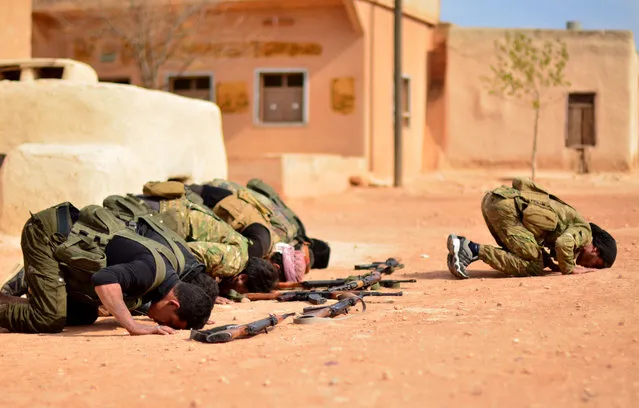 Free Syrian Army members perform prayer before they attack Daesh positions at Tel Madik village of Mari district in Aleppo, Syria on October 25, 2016. The villages were cleared as part of Turkeys Operation Euphrates Shield. The anti-Daesh operation called “Euphrates Shield”, which was launched on August 24, aims at improving security, supporting coalition forces, supporting Syrias territorial integrity and eliminating the terror threat along Turkeys border through Free Syrian Army (FSA) fighters backed by Turkish armor, artillery, tanks and jets. (Photo by Huseyin Nasir/Anadolu Agency/Getty Images)