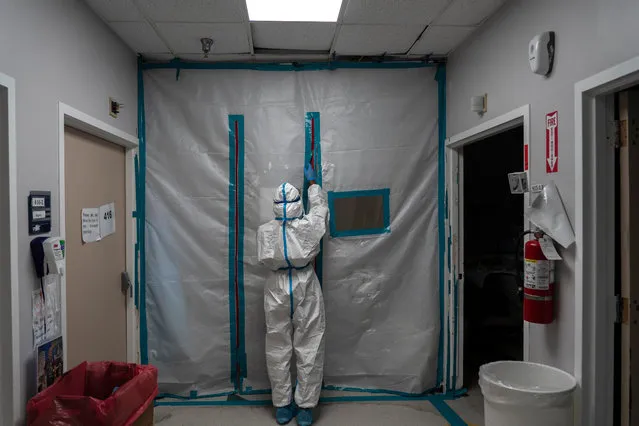 A medical staff exits the COVID-19 intensive care unit (ICU) on New Year's Day at the United Memorial Medical Center on January 1, 2021 in Houston, Texas. According to reports, Texas has reached over 1,760,000 cases, including over 27,800 deaths. (Photo by Go Nakamura/Getty Images)