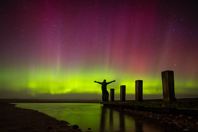 Incredible images capture the northern lights (aurora borealis) seen from the United Kingdom. The stunning colours were seen in the Monday night, April 3, 2025 from Findhorn Beach, Moray, Scotland. The Aurora is an incredible light show caused by collisions between electrically charged particles released from the sun that enter the earth's atmosphere and collide with gases such as oxygen and nitrogen. The lights are seen around the magnetic poles of the northern and southern hemispheres. (Photo by Paul Scott/CMA)
