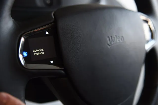 An option for autopilot is offered on the 1.8" inch steering wheel touchscreen on a mockup of the Mobi/us autonomous dashboard by Valeo, a concept for interacting with a self-driving car as well as with one's smartphone,  January 6, 2015 at the Consumer Electronics Show in Las Vegas, Nevada. By pressing for two seconds on the touchscreen the driver can switch between autopilot mode and traditional driving mode. (Photo by Robyn Beck/AFP Photo)