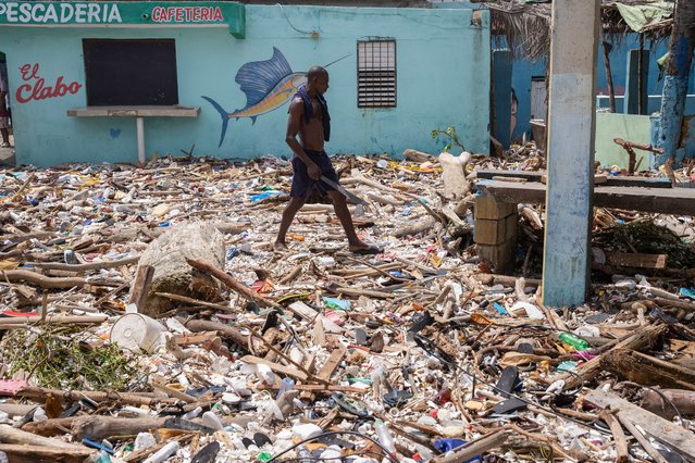 A man walks along the beach of Manresa, covered with garbage after the passage of Hurricane Beryl, in Santo Domingo, Dominican Republic, 3 July 2024. The Dominican Republic and Haiti emerged almost unscathed from the passage of Hurricane Beryl, whose main effect on the island of Hispaniola, shared by both countries, was the heavy swell that hit the Caribbean coast, and a few electricity and water supply issues. (Photo by Orlando Barria/EPA/EFE)