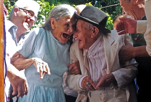 Paraguayan Anacleto Escobar (R), veteran of the Chaco War (1932-1935) fought between Paraguay and Bolivia, and his wife Cayetana Roman, smile during a ceremony coinciding with his 100th birthday in which they received a house – the first in their lives they own – as a gift for his merits, in Neembucu, Paraguay, on January 7, 2015. The event was organized by the governor of the state of Neembucu, Carlos Silva, to honour Escobar. (Photo by AFP Photo/Stringer)