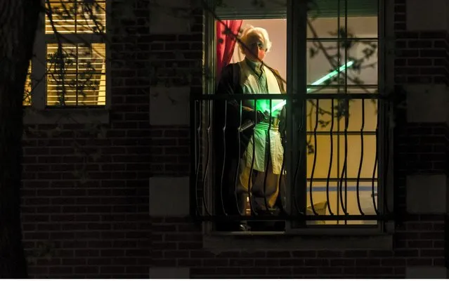 Jedi Ambassador of The Chicago Jedi, Dan McCann, 56, standing in his window in Chicago, Illinois on May 3, 2020. Normally, Dan would be preparing for The Galactic Battle For Chi-Town, a yearly mock Lightsaber battle in Chicago, which this year is being done via selfies shared over Facebook due to Illinois and Chicago's Stay At Home order. (Photo by Chris Riha/ZUMA Wire/Rex Features/Shutterstock)