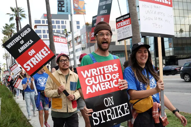 Oscar-winning directors Daniel Kwan and Daniel Scheinert, known collectively as the Daniels, march with Writers Guild of America members outside Sunset Bronson Studios and Netflix Studios, after union negotiators called a strike for film and television writers, in Los Angeles, California, U.S., May 3, 2023. (Photo by Mario Anzuoni/Reuters)
