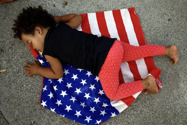 A child sleeps on the flag of the United States during a protest against migration retention policy on April 23, 2023 in Tapachula, Mexico.  (Photo by Jose torres/Agencia Press South/Getty Images)