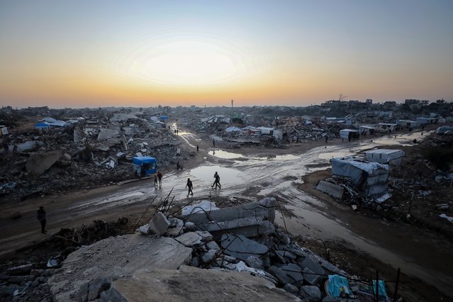 People walk among rubbles in the Zeitoun neighborhood, southeast of Gaza City, November 27, 2025. (Photo by Xinhua News Agency/Rex Features/Shutterstock)