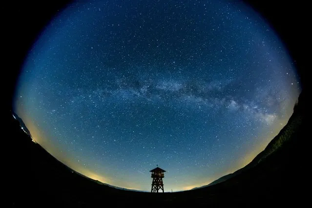 A picture take with a wide-angle lens shows the Milky Way is observed in the background of a lookout tower near the Hungarian border village of Tachty, or Tajti in Hungarian, Slovakia, late 28 August 2016. (Photo by Péter Komka/MTI/MTVA)
