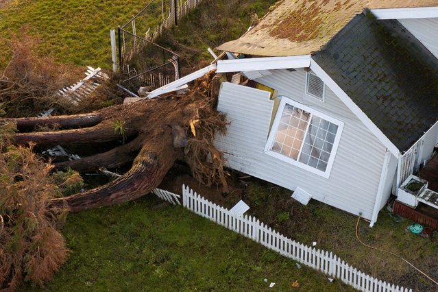 A drone view shows damage to a home after winds knocked down a tree, as extreme weather continues to batter the Pacific Northwest, in Tacoma, Washington, U.S., December 17, 2025. (Photo by David Ryder/Reuters)