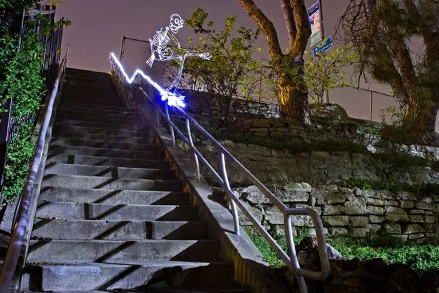 A light skateboarder grinding a rail. (Photo by Darren Pearson/Caters News)