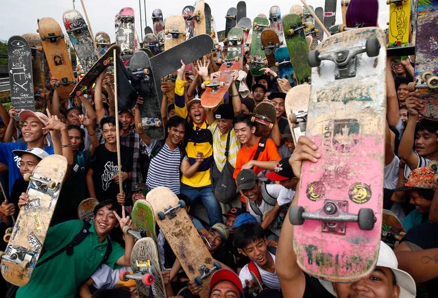 Skateboarders pose for a photo during a gathering of enthusiasts to mark Go Skateboarding Day in Manila, Philippines 21 June 2018. Skateboarders around the world celebrate Go Skateboarding Day to raise awareness and accessibility of skateboarding. The special day was initiated by the International Association of Skateboard Companies and is observed on 21 June. (Photo by Rolex Dela Pena/EPA/EFE)