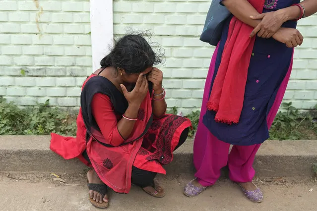 A woman cries while looking for her husband who was traveling in the train that derailed, in Balasore district, in the eastern Indian state of Orissa, Sunday, June 4, 2023. (Photo by Rafiq Maqbool/AP Photo)
