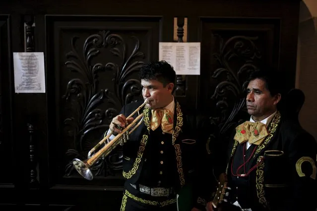 Mariachi musicians prepare to perform to celebrate the Day of the Virgin of Guadalupe outside the Basilica of Guadalupe in San Salvador, El Salvador December 11, 2015. (Photo by Jose Cabezas/Reuters)