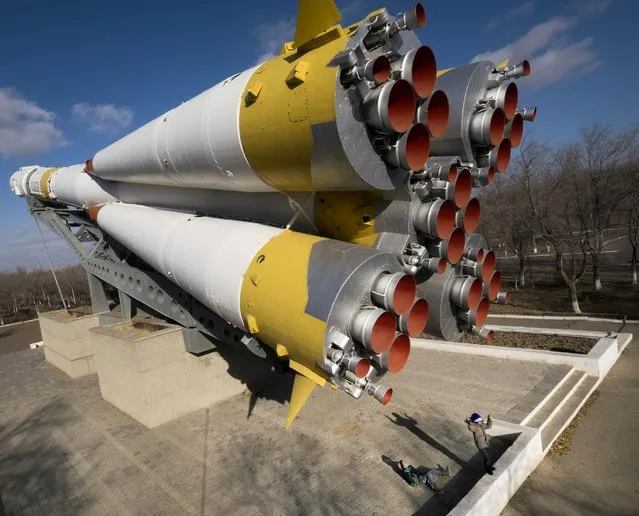 Boys play near a Soyuz rocket installed as a monument at the Russian leased Baikonur cosmodrome, the world's first and largest operational space launch facility, in Baikonur, Kazakhstan, Sunday, November 13, 2016. The new Soyuz mission to the International Space Station (ISS) is scheduled on early Friday, Nov. 18 local time. (Photo by Dmitri Lovetsky/AP Photo)