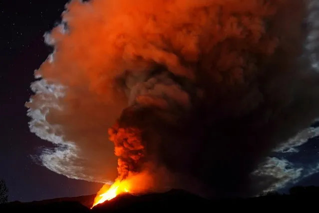 Large streams of red hot lava shoot into the night sky as Mount Etna, Europe's most active volcano, continues to erupt, as seen from the village of Fornazzo, Italy on February 23, 2021. (Photo by Antonio Parrinello/Reuters)