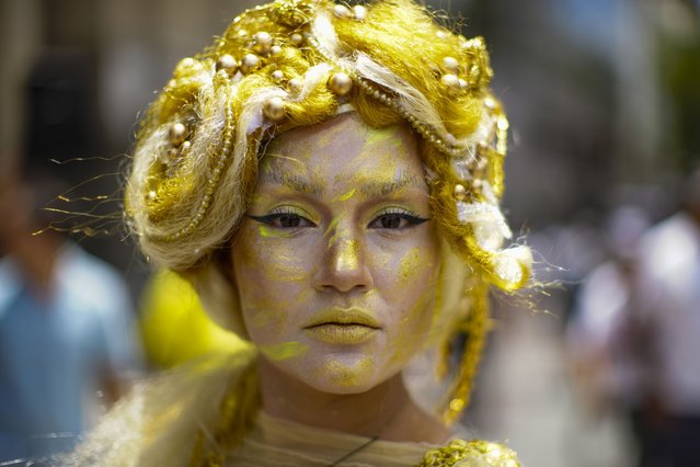 An actress representing the Three Wise Men's gift of gold poses for a photo during an Epiphany pre-event in the Plaza de Armas of Santiago, Chile, January 5, 2025. (Photo by Esteban Felix/AP Photo)