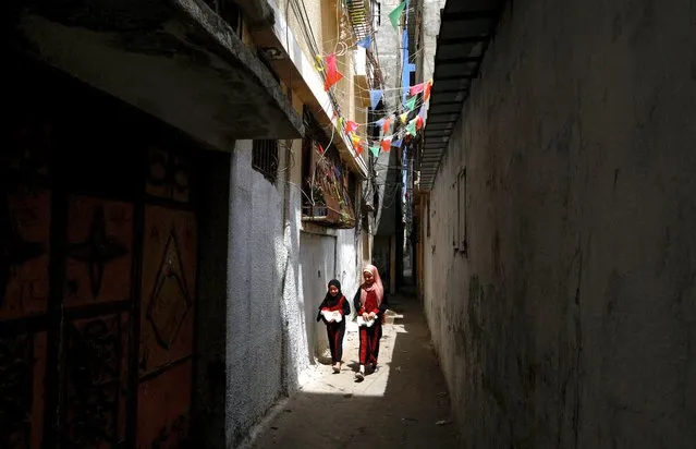 Palestinian refugee girls walk at Al-Shati refugee camp on World Refugee Day, in Gaza City on June 20, 2023. (Photo by Mohammed Salem/Reuters)