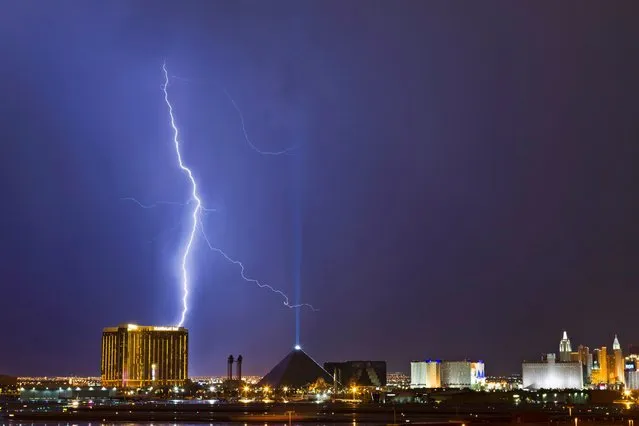 Lightning strikes above the Mandalay Bay and Luxor casinos on the Las Vegas Strip as a thunderstorm moves through Las Vegas, on July 21, 2013. (Photo by Steve Marcus/Reuters)