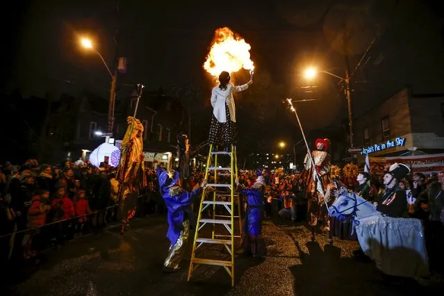 A performer blows fire from her mouth at the 26th Annual Kensington Market Winter Solstice Parade in Toronto, December 21, 2015. (Photo by Mark Blinch/Reuters)