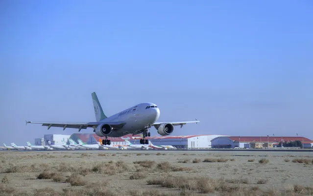 In this photo released by Imam Khomeini Airport City, an Iranian Mahan Air plane carrying Russian-made Sputnik V coronavirus vaccines lands at the Tehran's Imam Khomeini International Airport, Thursday, February 4, 2021. Iran on Thursday received its first batch of foreign-made coronavirus vaccines as the country struggles to stem the worst outbreak of the pandemic in the Middle East. (Photo by Saeed Kaari/IKAC via AP Photo)