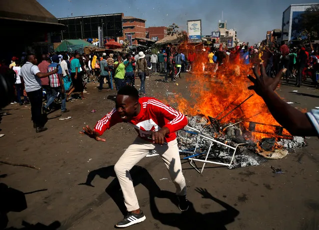 Supporters of the opposition Movement for Democratic Change party (MDC) of Nelson Chamisa react as they block a street in Harare, Zimbabwe, August 1, 2018. (Photo by Siphiwe Sibeko/Reuters)