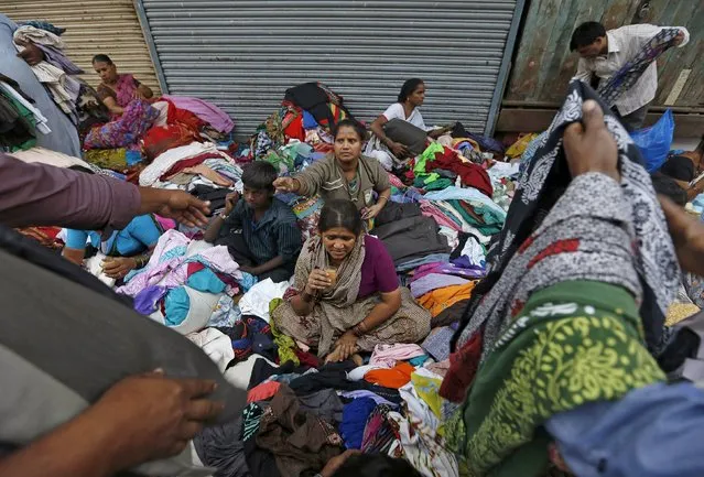 Vendors sell clothes at a second-hand street side clothing market in Mumbai, India, January 11, 2016. (Photo by Danish Siddiqui/Reuters)