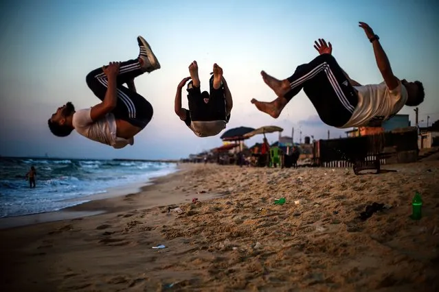 Palestinian youths from the freestyle parkour team in Gaza practice their skills at the beach in the northern Gaza Strip on August 29, 2023. (Photo by Mahmoud Issa/SOPA Images/Rex Features/Shutterstock)