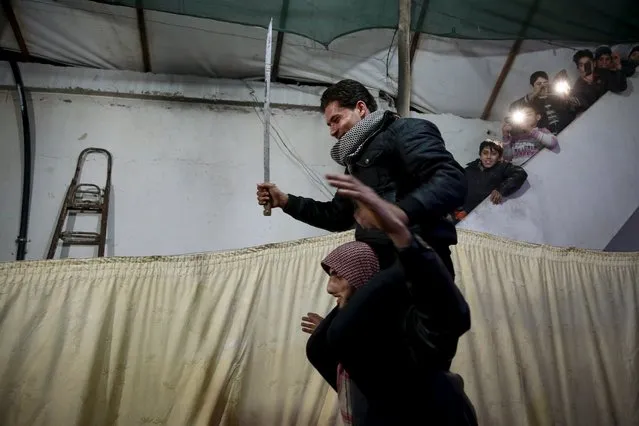 A fighter, whose face was wounded during clashes with forces loyal to Syria's president Bashar al-Assad, carries his friend, a Free Syrian Army fighter, during his wedding ceremony in the town of Douma, eastern Ghouta in Damascus, Syria January 19, 2016. (Photo by Bassam Khabieh/Reuters)